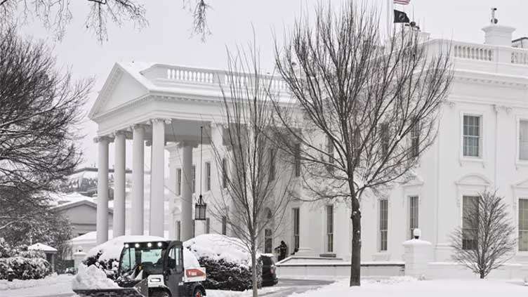 Winter storm leaves large US region blanketed in snow, ice