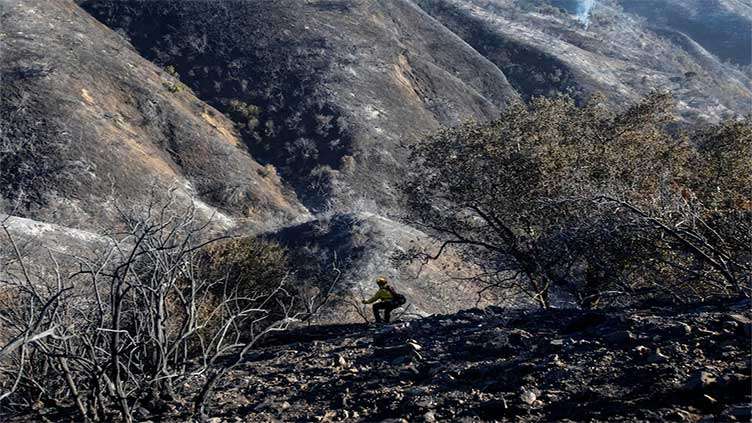 Los Angeles races to contain wildfires before severe winds return